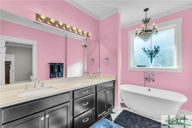 5261 Mill Branch Club Rd, Pembroke, GA 31321 - full bathroom with double vanity, a chandelier, a freestanding tub, and baseboards