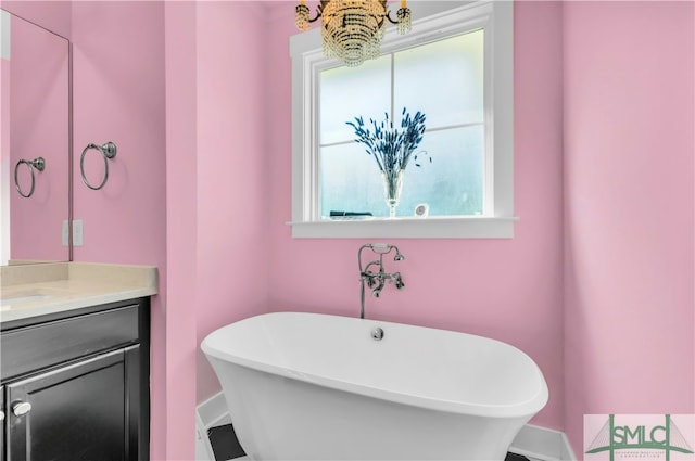 bathroom featuring vanity, a tub to relax in, and plenty of natural light