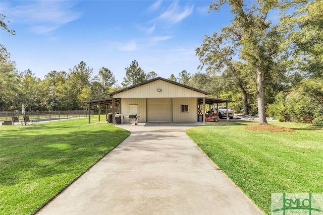 exterior space featuring a front lawn, an outbuilding, and a carport