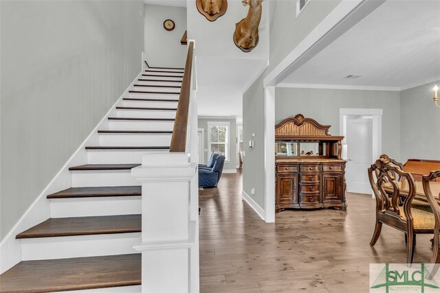 5261 Mill Branch Club Rd, Pembroke, GA 31321 - staircase with wood finished floors and ornamental molding