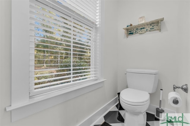 bathroom featuring toilet and tile patterned flooring