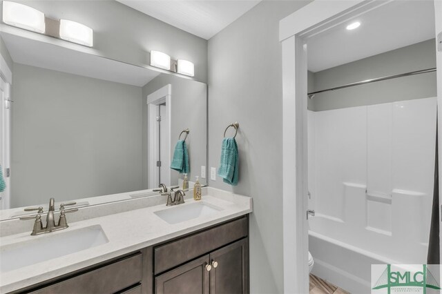 5261 Mill Branch Club Rd, Pembroke, GA 31321 - bathroom with double vanity, toilet, and shower / washtub combination