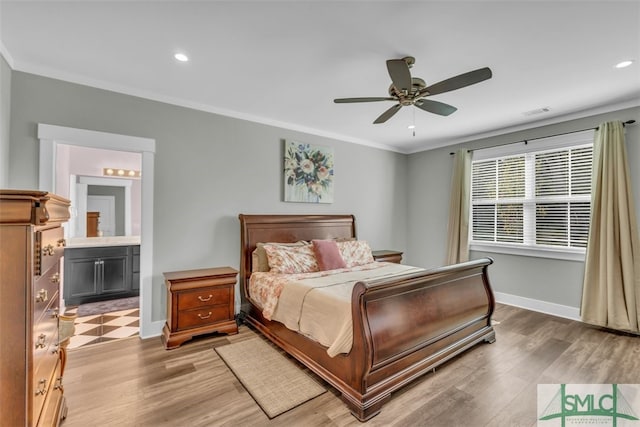 bedroom with ornamental molding, light hardwood / wood-style flooring, ceiling fan, and ensuite bath