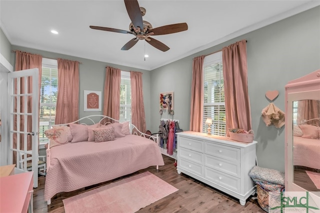 bedroom with light hardwood / wood-style floors, multiple windows, and ceiling fan