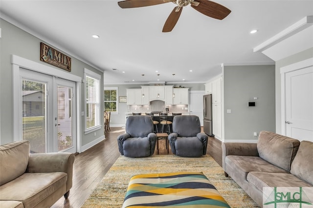 living room featuring crown molding, hardwood / wood-style flooring, a healthy amount of sunlight, and ceiling fan