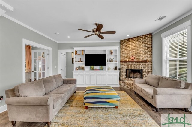5261 Mill Branch Club Rd, Pembroke, GA 31321 - living room with wood finished floors, ceiling fan, a brick fireplace, ornamental molding, and recessed lighting