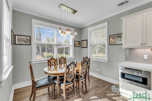 5261 Mill Branch Club Rd, Pembroke, GA 31321 - dining area featuring a chandelier, wood finished floors, ornamental molding, and baseboards