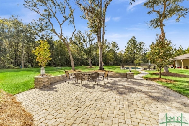 5261 Mill Branch Club Rd, Pembroke, GA 31321 - view of patio / terrace with an outdoor fire pit and view of wooded area