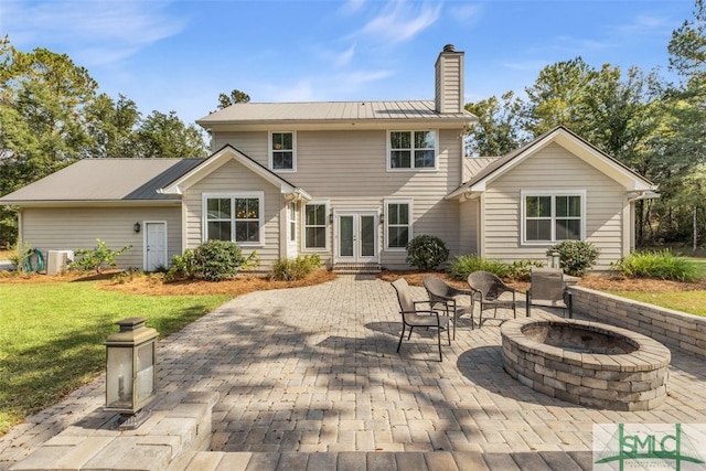 back of house with a patio area and a fire pit