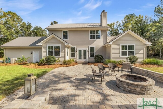 5261 Mill Branch Club Rd, Pembroke, GA 31321 - back of property with french doors, a chimney, a patio, a fire pit, and a yard