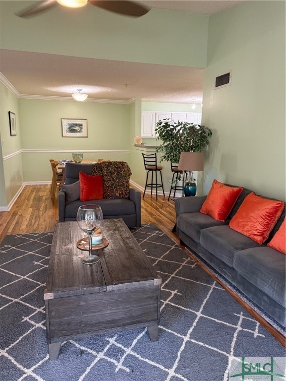 living room featuring crown molding and dark hardwood / wood-style floors