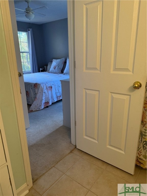 tiled bedroom with ceiling fan