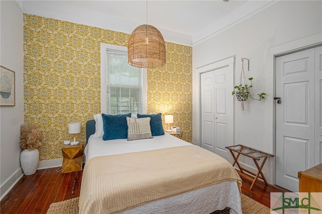 bedroom featuring crown molding and dark wood-type flooring