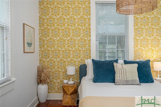 bedroom with wood-type flooring and multiple windows