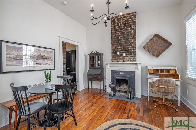 dining space featuring a notable chandelier and wood-type flooring