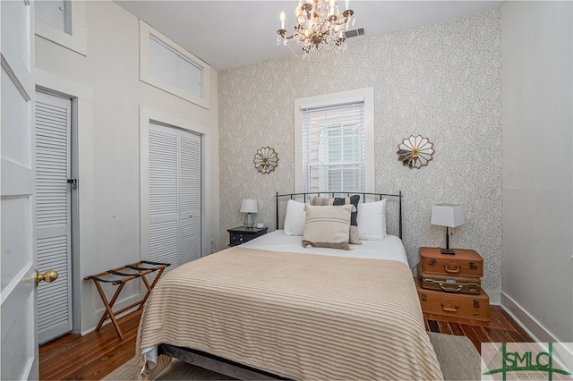 bedroom featuring dark hardwood / wood-style floors and a notable chandelier