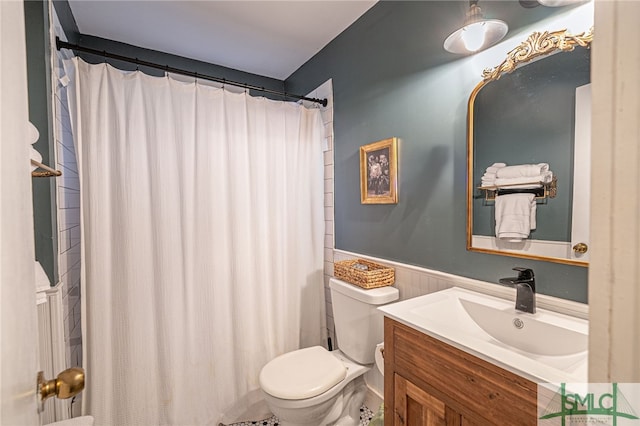 bathroom featuring walk in shower, vanity, and toilet