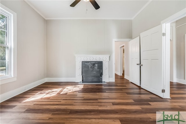 unfurnished living room featuring crown molding, ceiling fan, and dark hardwood / wood-style floors