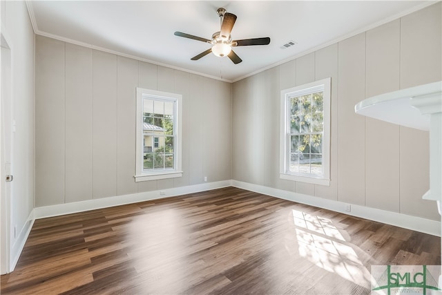 spare room featuring crown molding, dark wood-type flooring, and ceiling fan