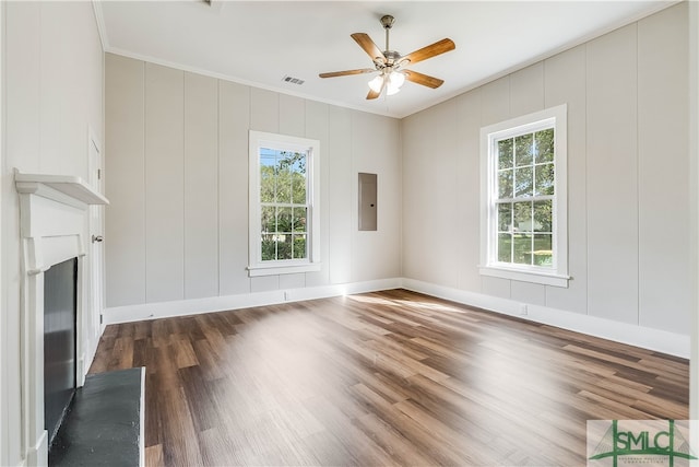 unfurnished living room featuring ornamental molding, plenty of natural light, and dark hardwood / wood-style flooring