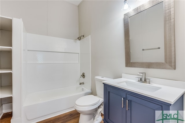 full bathroom featuring vanity, hardwood / wood-style floors, shower / bathtub combination, and toilet