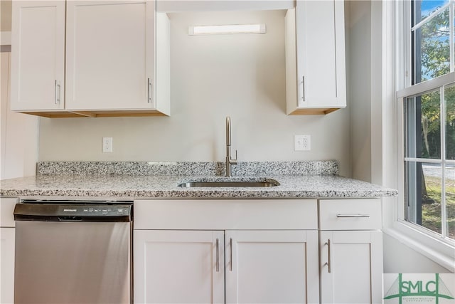 kitchen with dishwasher, sink, and white cabinets