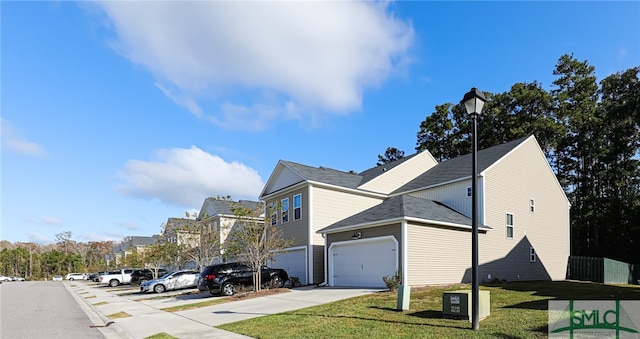 view of home's exterior with a garage and a lawn