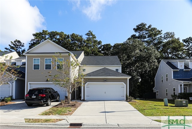 view of property with a front lawn and a garage