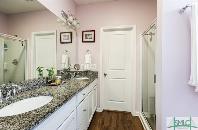 bathroom featuring vanity, walk in shower, and hardwood / wood-style flooring