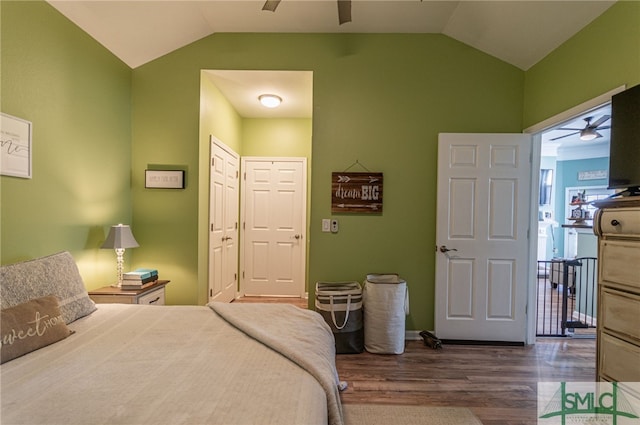 bedroom featuring a ceiling fan, vaulted ceiling, and dark wood-style flooring