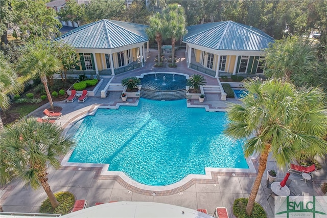 pool with a patio and a jacuzzi