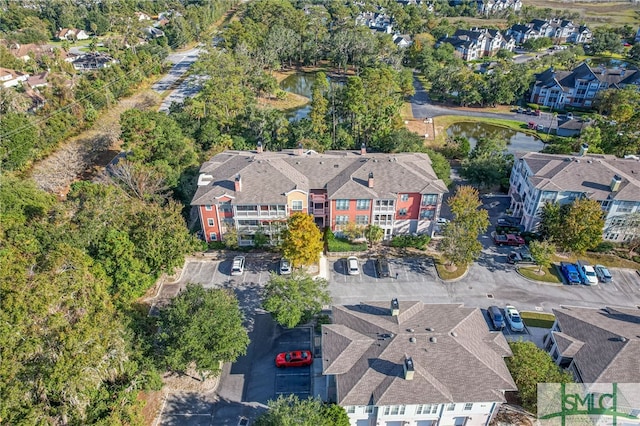 birds eye view of property featuring a residential view and a water view