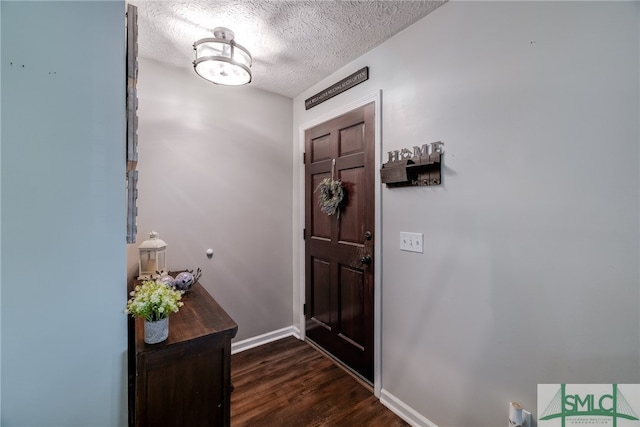 entryway with a textured ceiling and dark hardwood / wood-style flooring