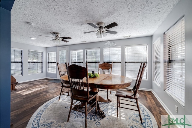 dining space featuring a textured ceiling, dark wood-type flooring, and ceiling fan