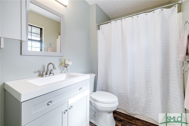 bathroom with vanity, a textured ceiling, toilet, and hardwood / wood-style flooring