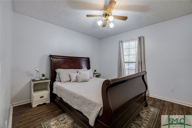 bedroom with dark hardwood / wood-style floors, a textured ceiling, and ceiling fan