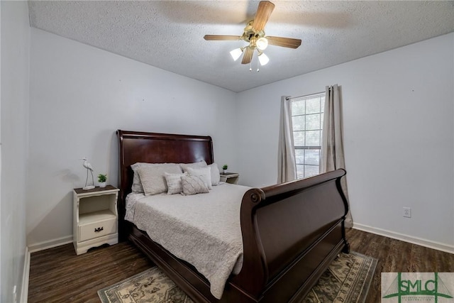 bedroom with a textured ceiling, ceiling fan, and dark hardwood / wood-style flooring