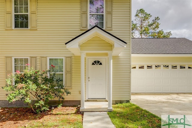 view of exterior entry with a garage