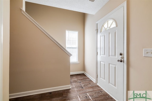 foyer featuring a textured ceiling and hardwood / wood-style floors