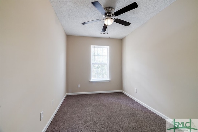 spare room featuring dark colored carpet, a textured ceiling, and ceiling fan