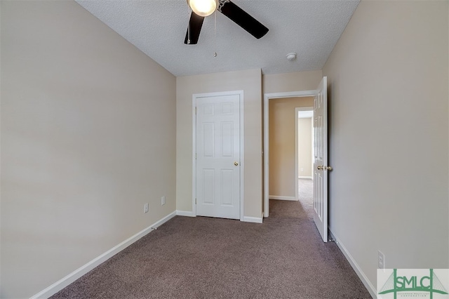 unfurnished bedroom with a textured ceiling, carpet floors, and ceiling fan