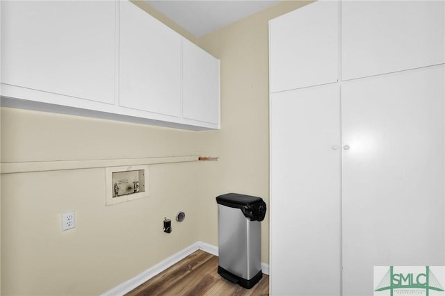 washroom featuring cabinets, dark hardwood / wood-style floors, and washer hookup