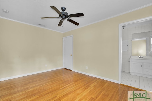 spare room featuring light hardwood / wood-style floors, ceiling fan, crown molding, and sink