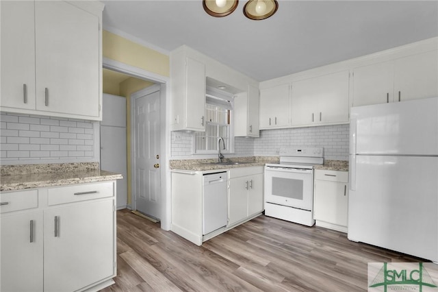 kitchen with white appliances, sink, backsplash, and white cabinetry