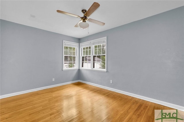 spare room with ceiling fan and wood-type flooring