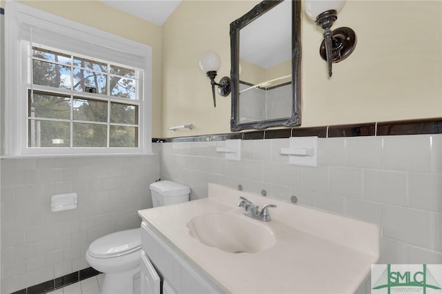 bathroom featuring tile walls, tile patterned floors, vanity, and toilet