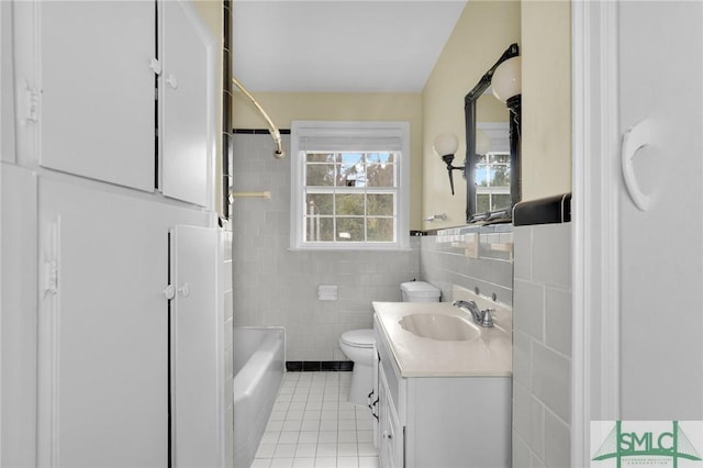 full bathroom with toilet, tile walls, shower / bathing tub combination, tile patterned floors, and vanity