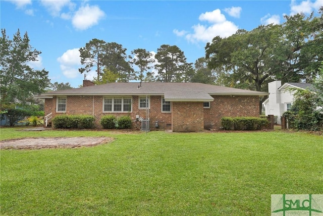 back of property featuring a yard