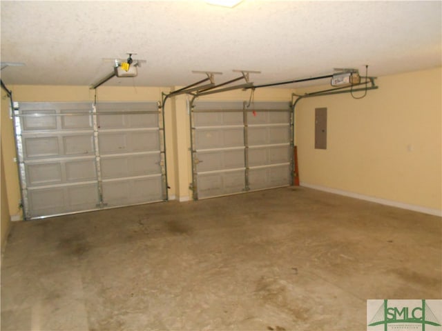 garage with a garage door opener and electric panel