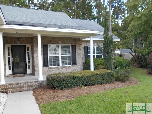 property entrance featuring a lawn